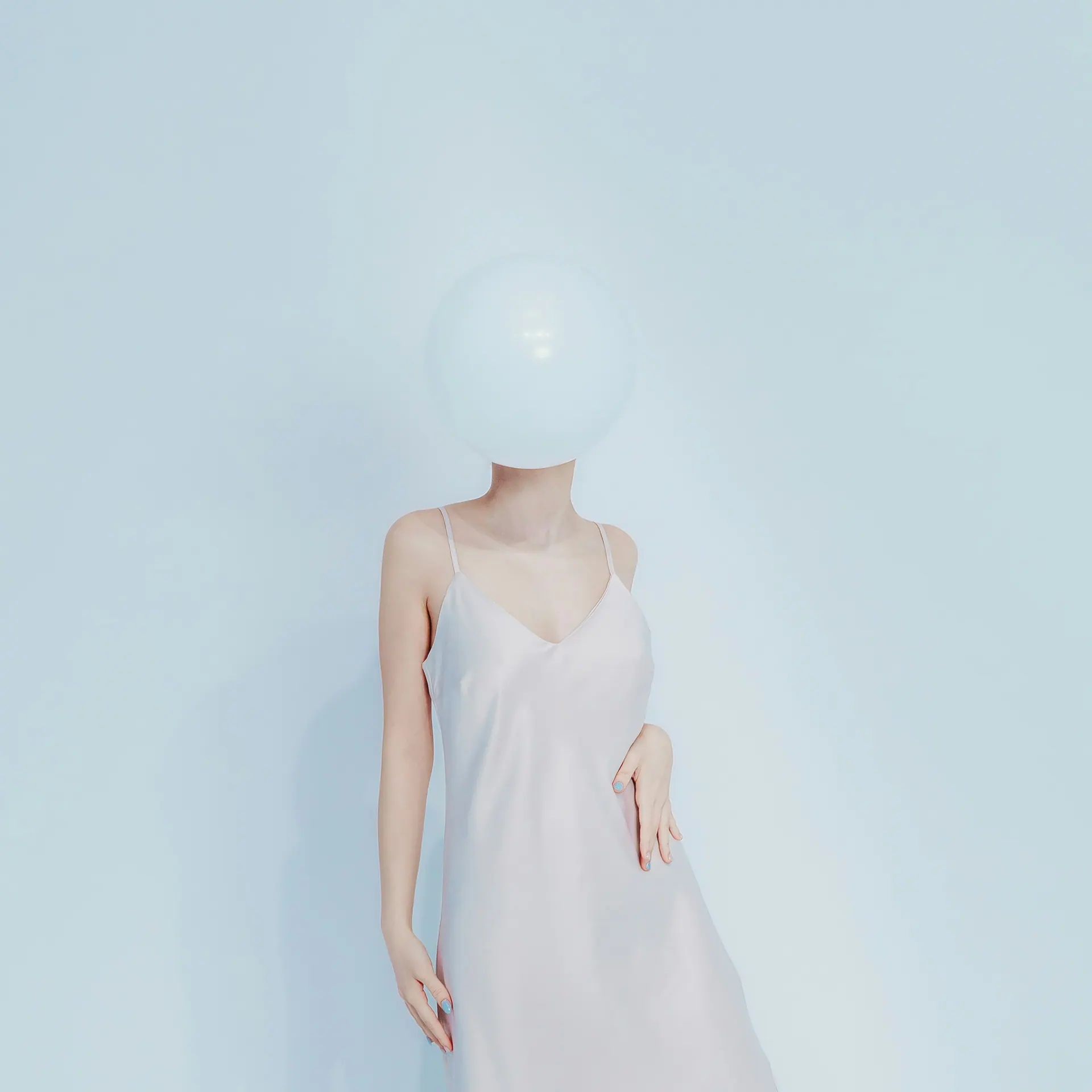 Pale dress with a reflective sphere